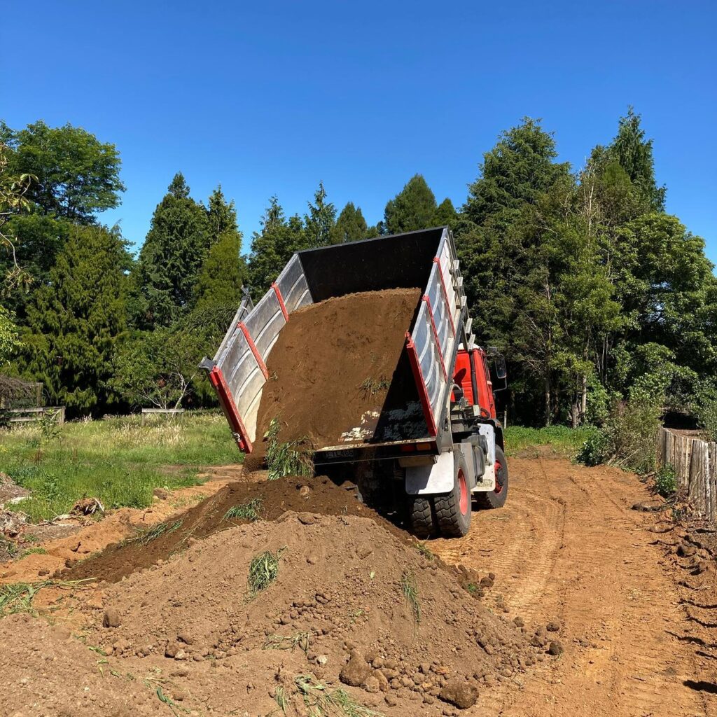Tipping truck delivering soil
